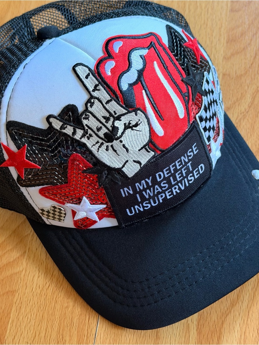 Black Trucker Hat with Red Graphic Patch and Statement Detail